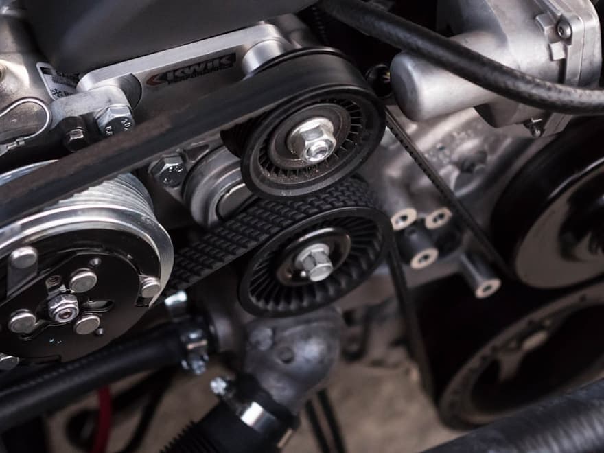 Serpentine belt and alternator pulleys in an engine bay