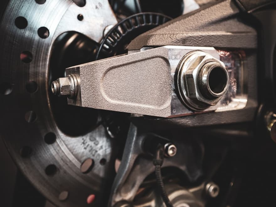 Wheel hub and bearing assembly behind a brake rotor